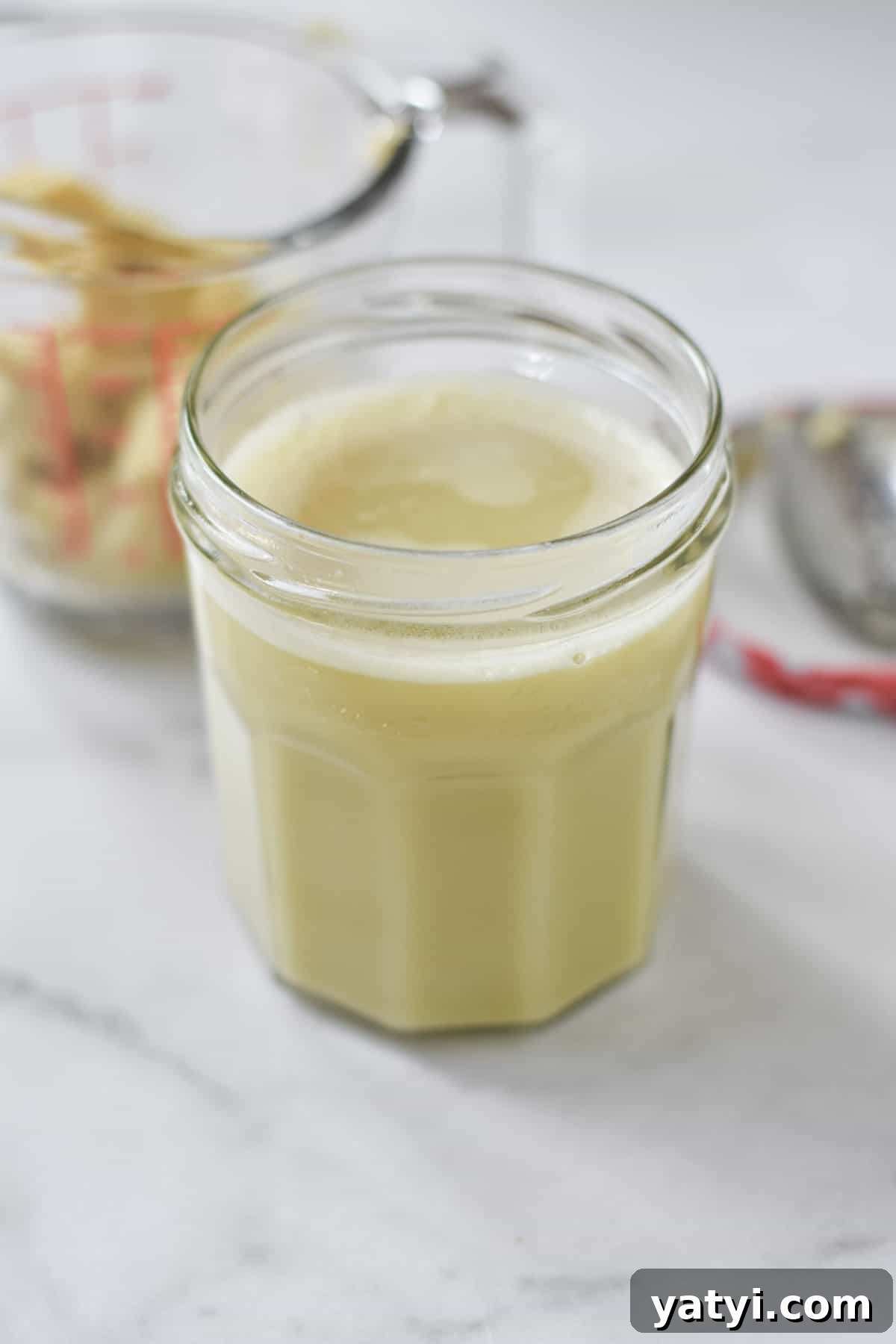 Ginger Juice Recipe: Make Fresh Ginger Juice with a Blender or Juicer 6 A container of ginger juice for storage with ginger pulp next to it.