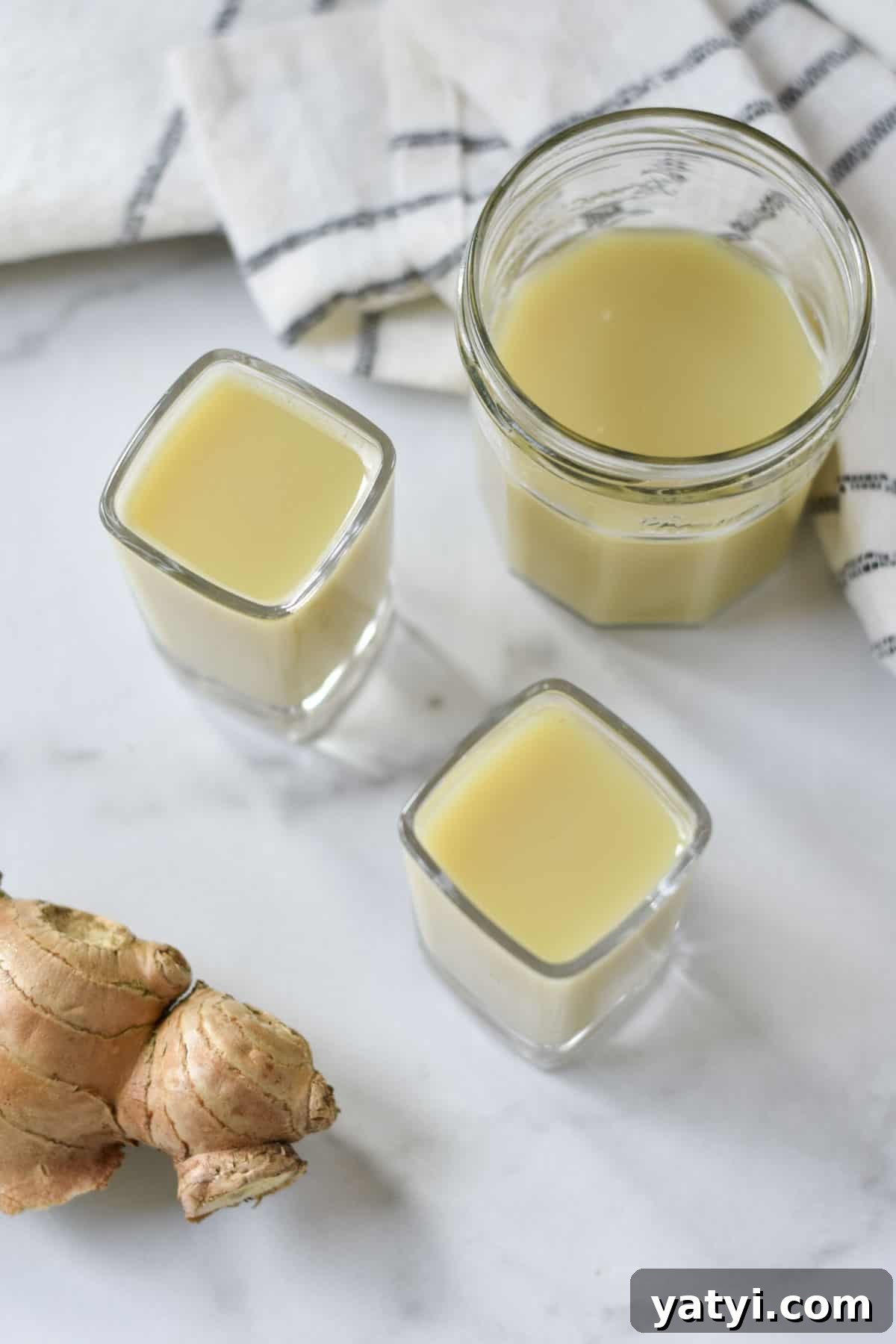 Ginger Juice Recipe: Make Fresh Ginger Juice with a Blender or Juicer 8 Ginger juice shots on a table.