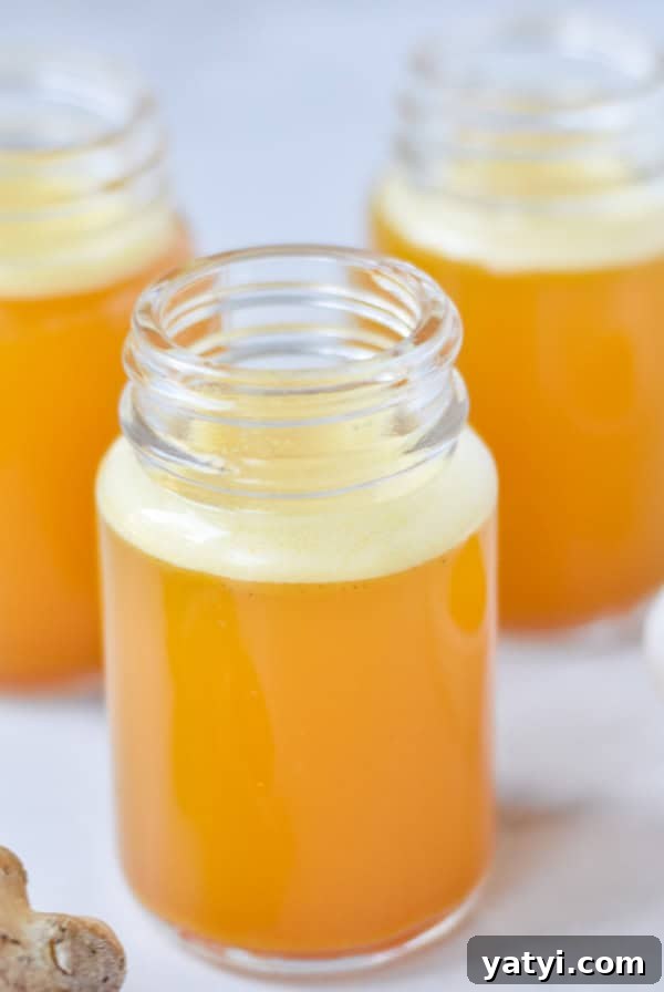 Ginger Juice Recipe: Make Fresh Ginger Juice with a Blender or Juicer 10 Three ginger turmeric shots in glass bottles next to fresh ginger root and turmeric.