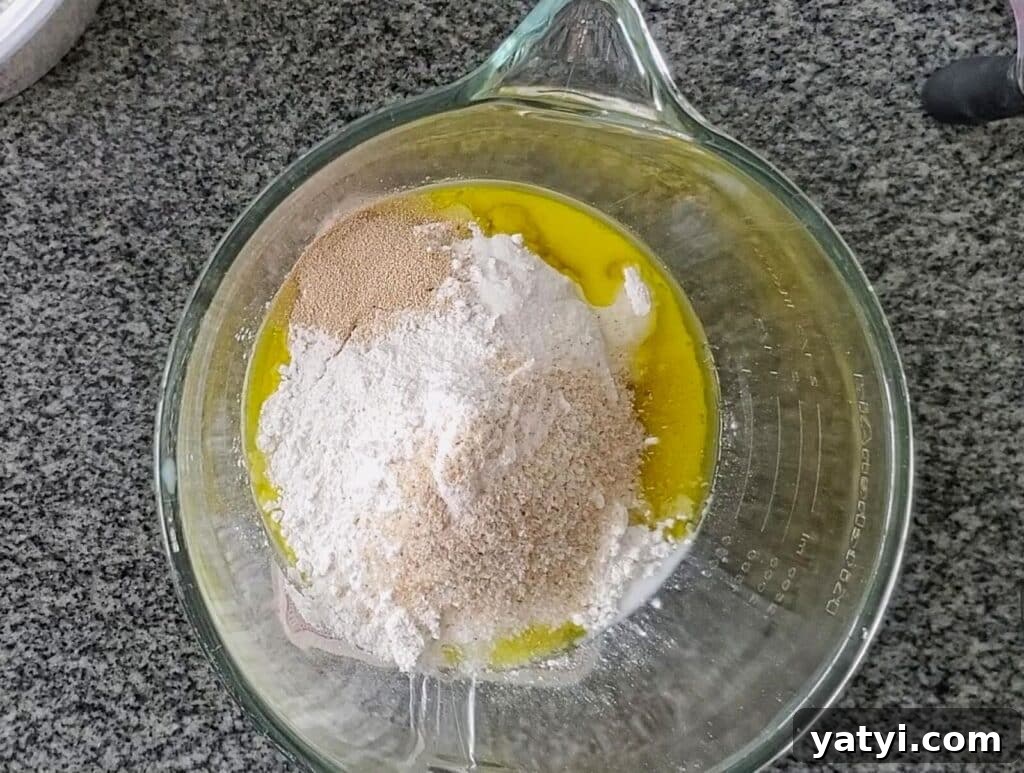 Gluten-Free Pita Bread Recipe: Soft, Flavorful, and Simple 3 all ingredients for dough in glass mixing bowl.