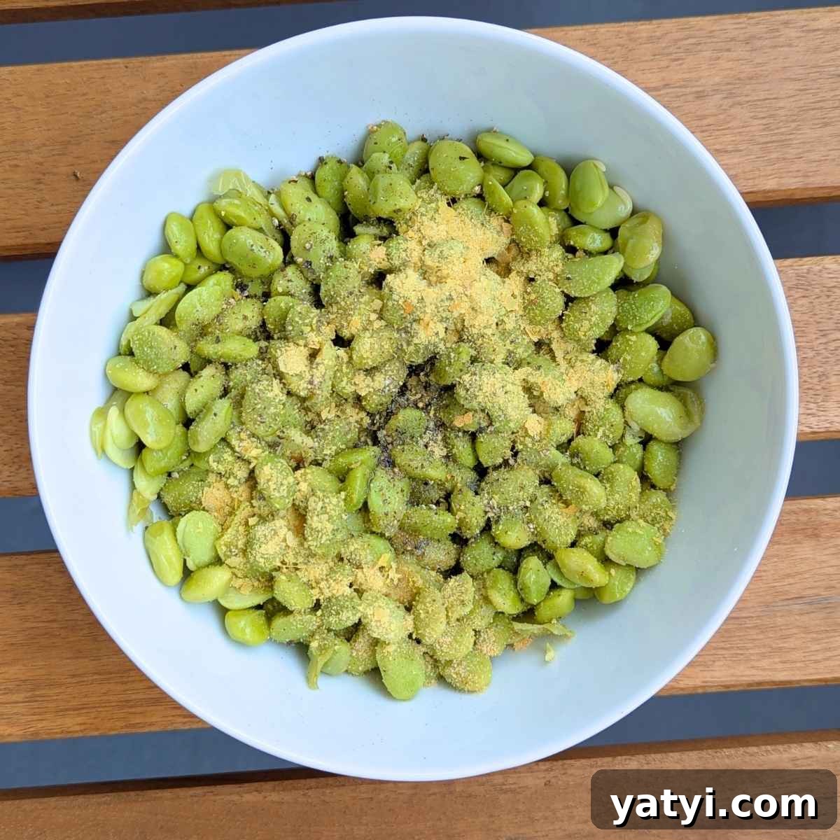 Crispy Air Fryer Edamame Recipe for a Perfect Snack 5 Edamame beans in a bowl tossed with olive oil and seasonings