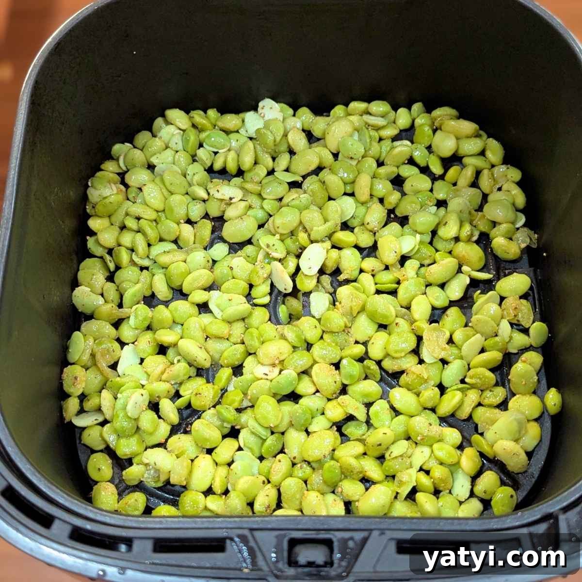 Crispy Air Fryer Edamame Recipe for a Perfect Snack 6 Seasoned edamame beans in air fryer basket