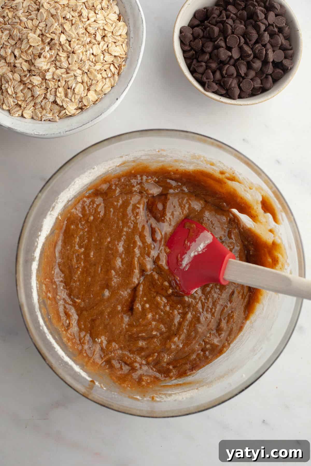 Chewy Brown-Butter Oatmeal Cookies with Chocolate Chips 7 Cookie dough in a large glass bowl.