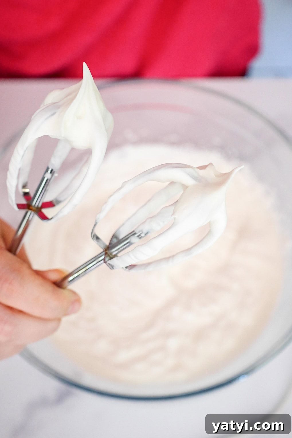 No-Bake Strawberry Cheesecake Cups with Graham Cracker Crust 4 Electric beaters with stiff whipped cream peaks above a glass bowl.