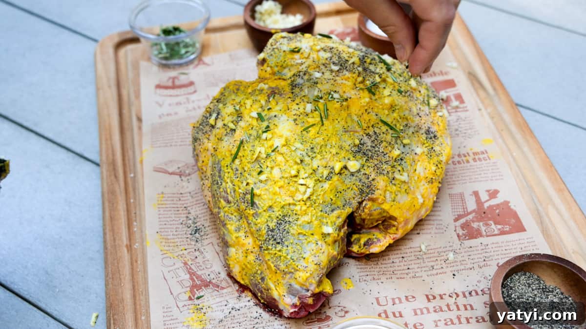 Juicy Smoked Leg of Lamb Recipe for Tender, Flavorful Roast 4 Seasoned leg of lamb on cutting board atop table.