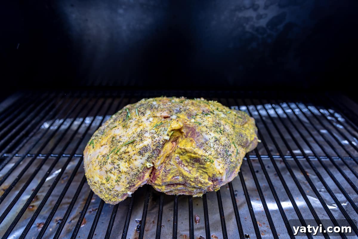 Juicy Smoked Leg of Lamb Recipe for Tender, Flavorful Roast 6 Lamb roast on grill grates of smoker.