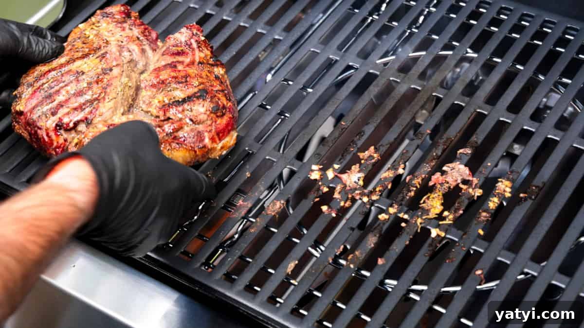 Juicy Smoked Leg of Lamb Recipe for Tender, Flavorful Roast 7 Lamb roast seared on hot grill. Flipping by hand while wearing black gloves.