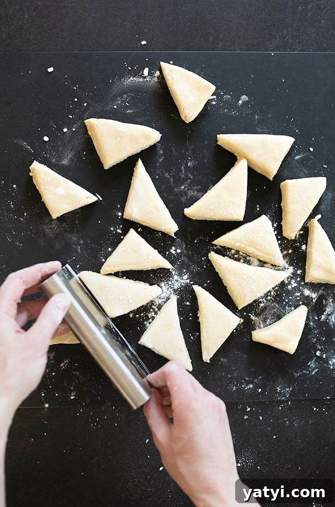 Gluten-Free Vanilla Scones Inspired by Starbucks 4 Hands cutting triangles of dough.