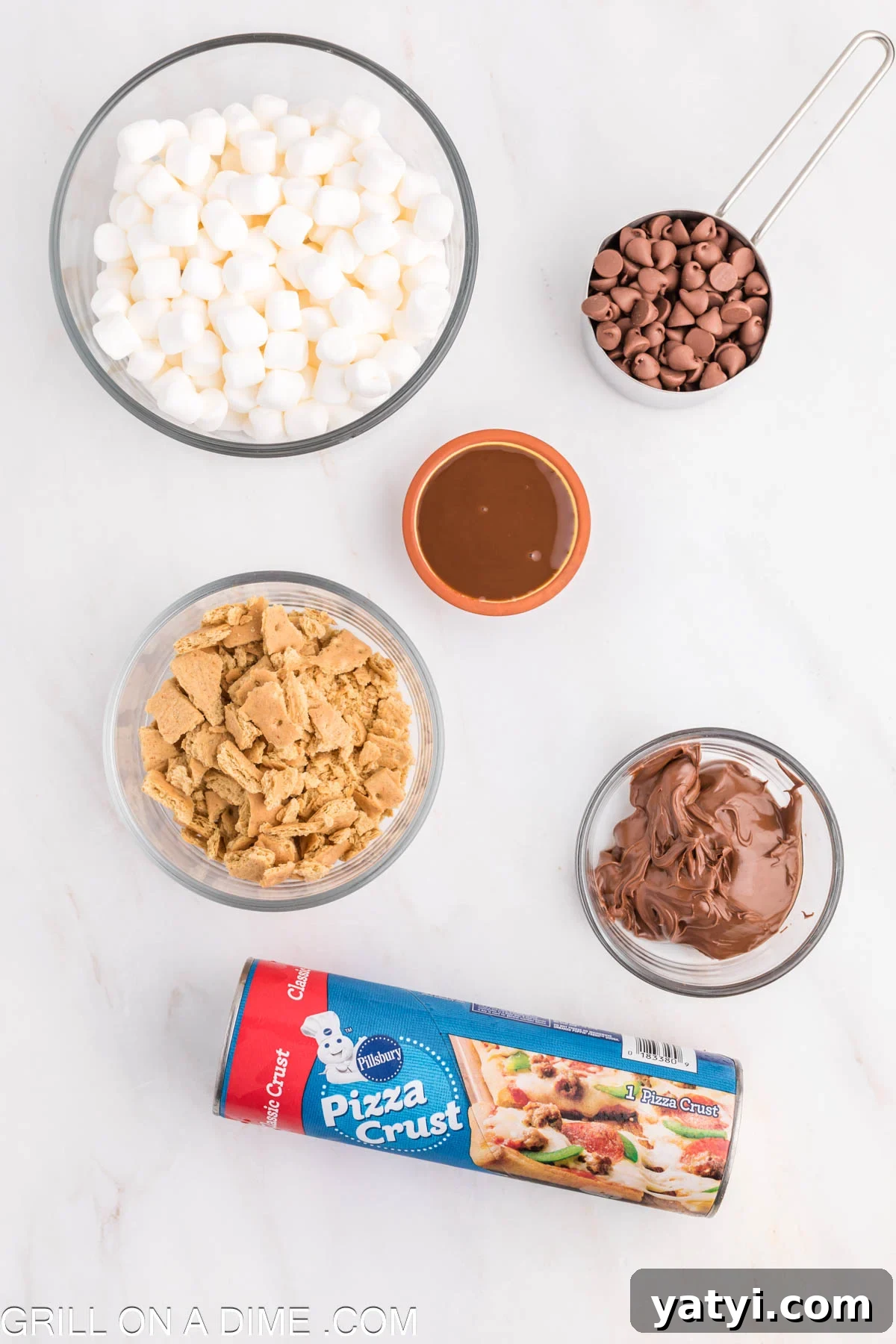 Ingredients needed - pizza crust, nutella, graham crackers, marshmallows, chocolate chips, chocolate sauce