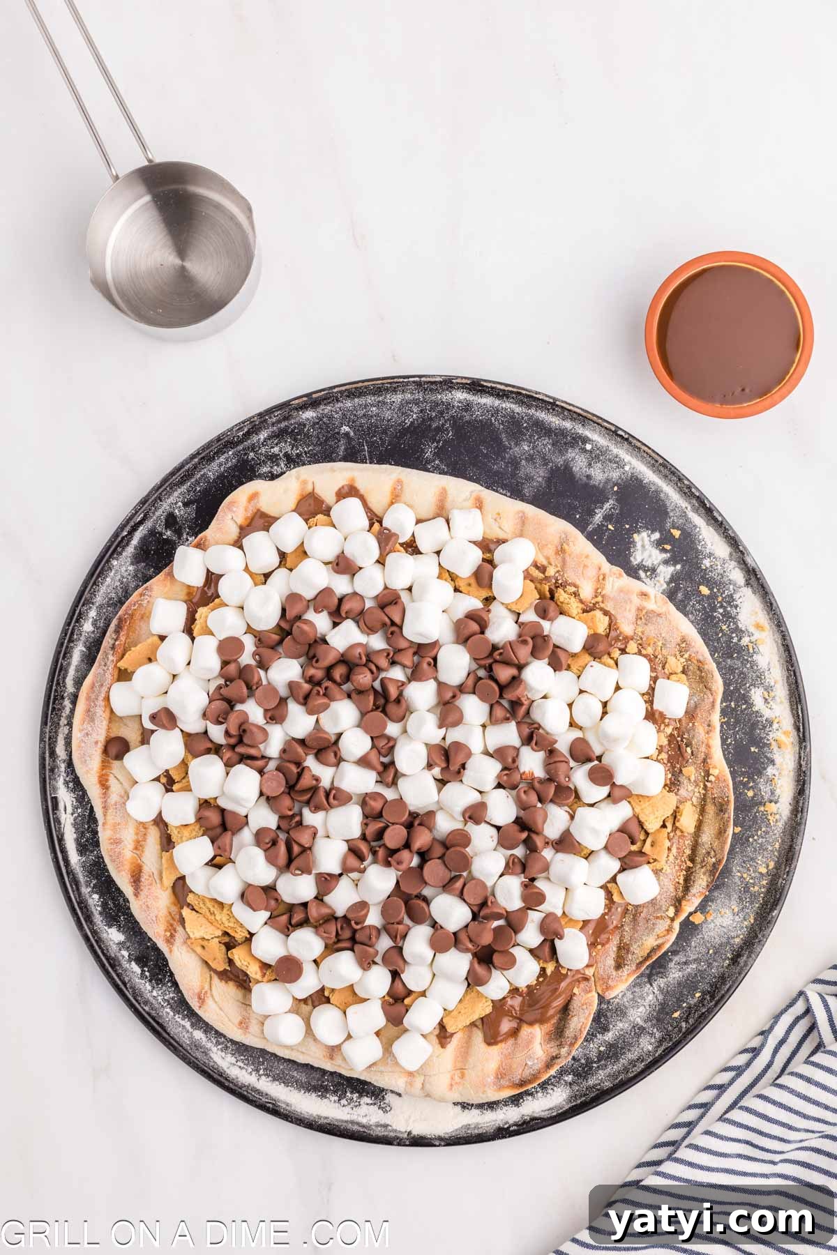 Pizza crust topped with marshmallows and chocolate chips