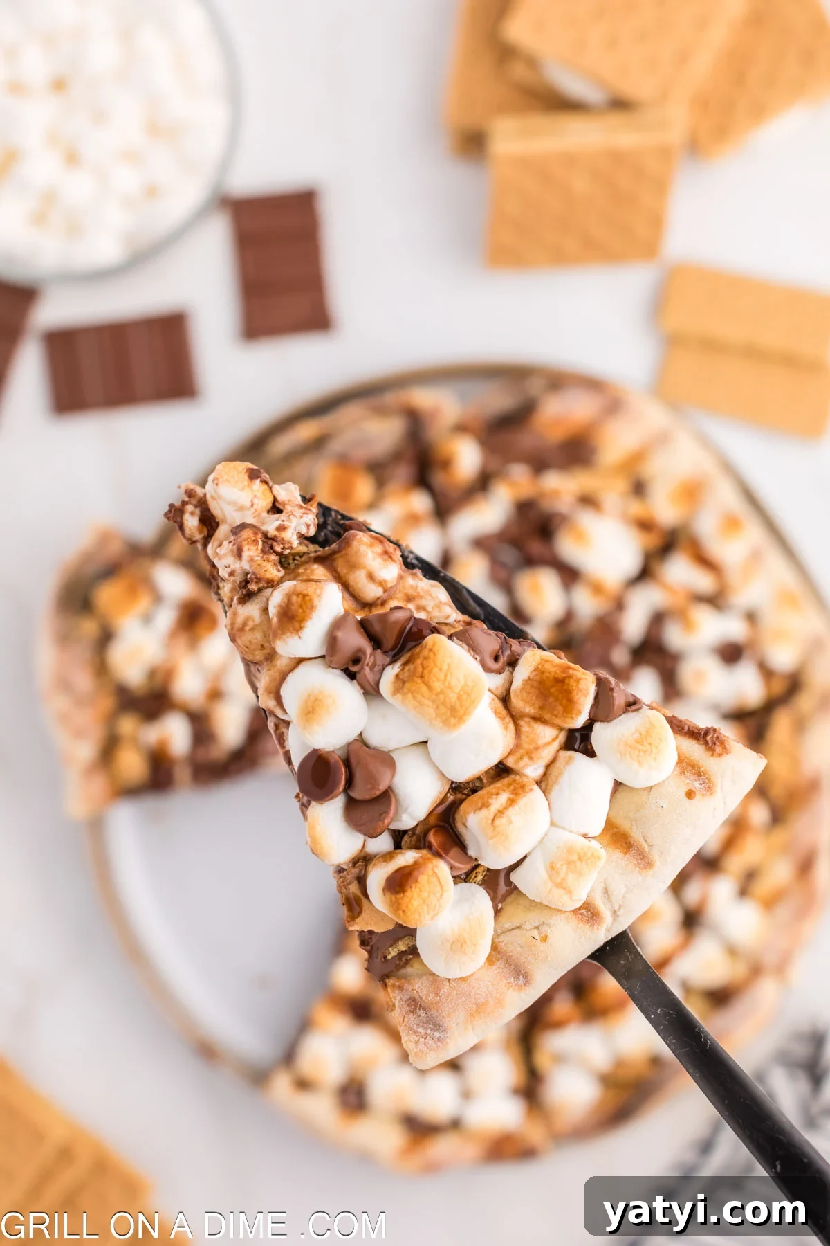 Slice of S'mores pizza on a spatula