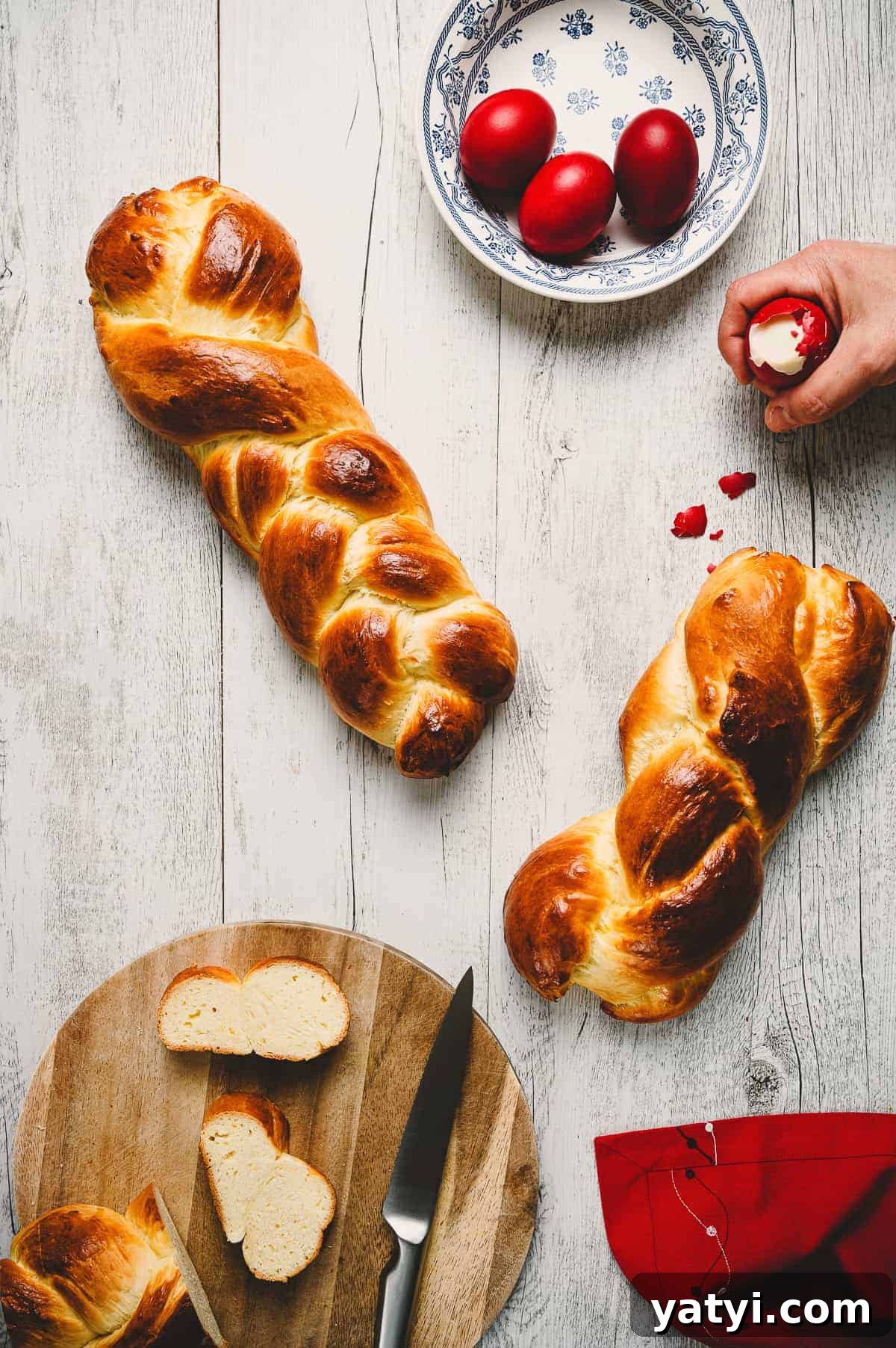 Greek Easter Traditions: Customs, Foods, and Celebrations Explained 11 two Greek Easter breads on a white wooden table