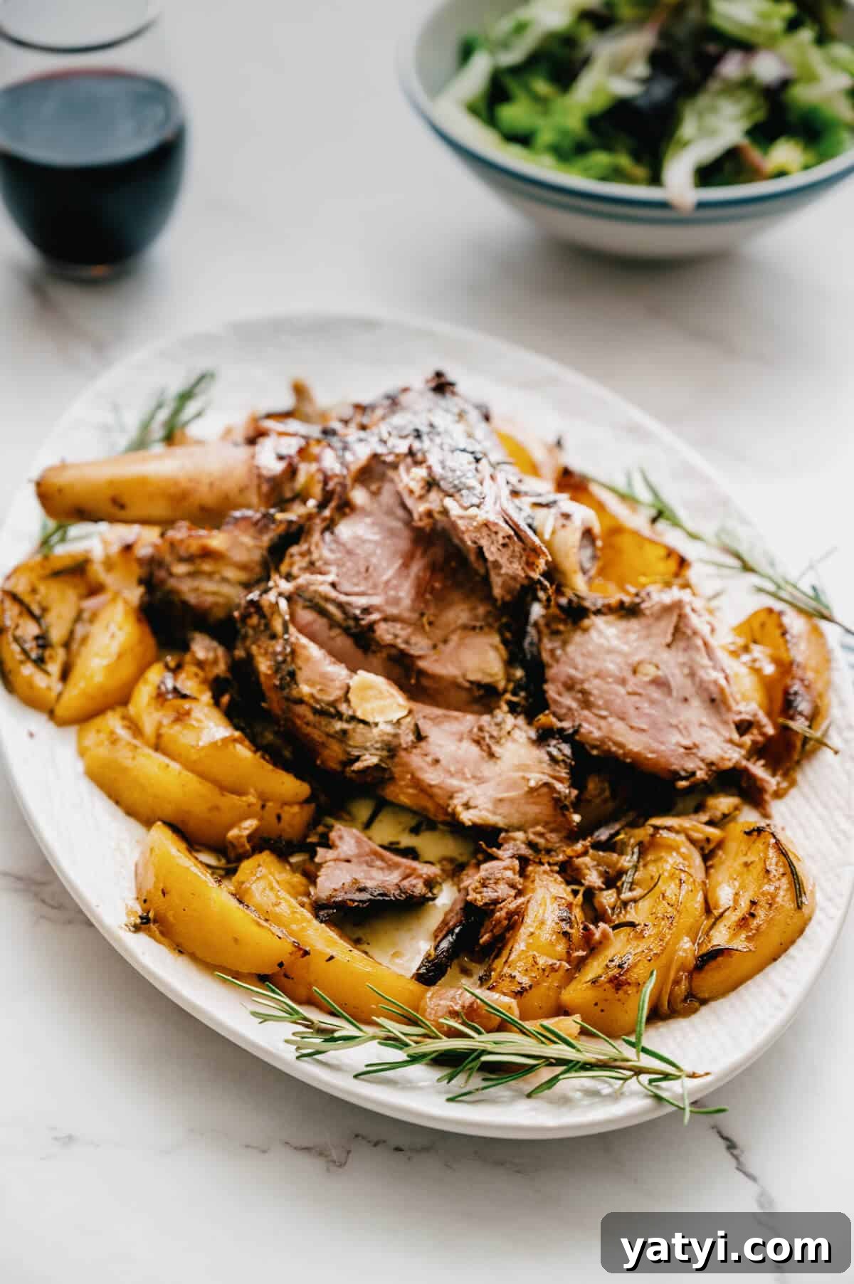 Greek Easter Traditions: Customs, Foods, and Celebrations Explained 12 a platter with carved lamb and roast potatoes.