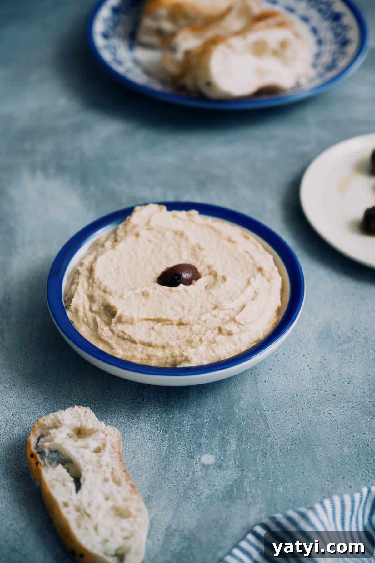 Greek Easter Traditions: Customs, Foods, and Celebrations Explained 4 a bowl of taramasalata on a grey table with bread.