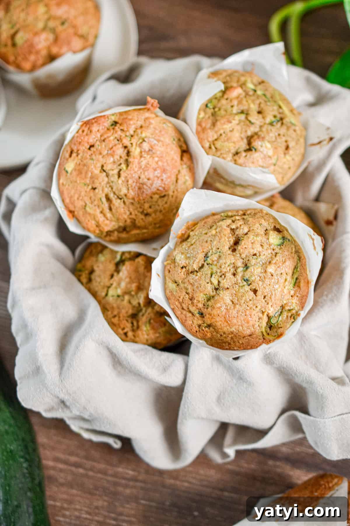 Sourdough Discard Zucchini Muffins Recipe (Quick & Moist) 2 The sourdough discard zucchini muffins are piled high in a bowl.