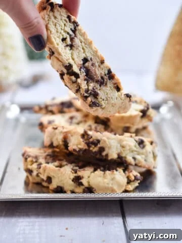 A hand is picking up one sourdough biscotti
