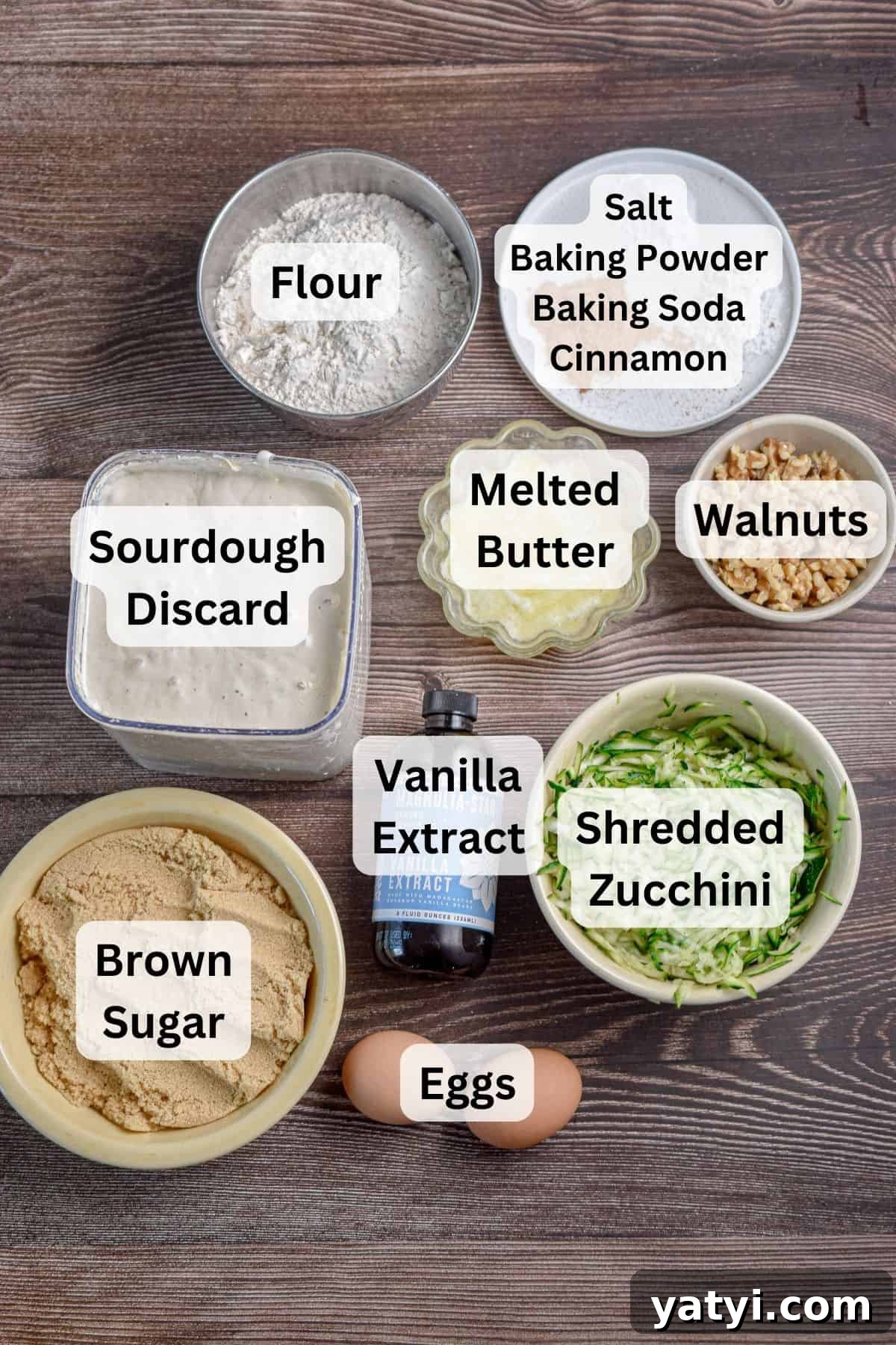 Sourdough Discard Zucchini Muffins Recipe (Quick & Moist) 3 The ingredients for the sourdough discard zucchini muffins are laid out and labeled.