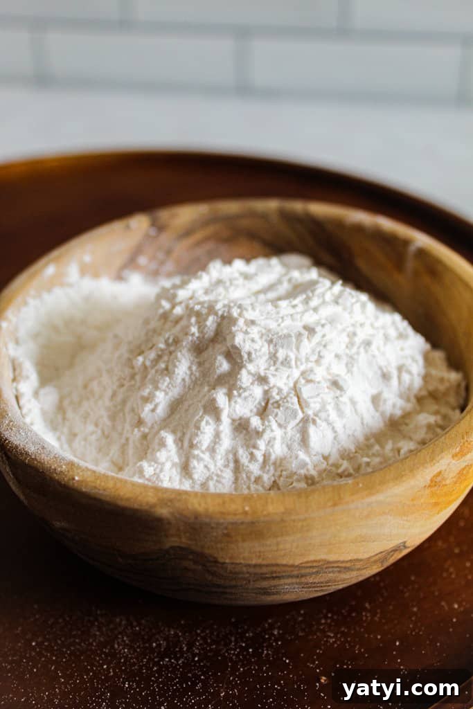 Xanthan Gum vs Arrowroot: wooden bowl of tapioca starch.