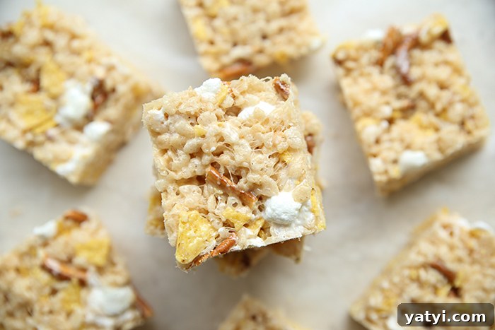 A few cut sweet and salty rice Krispy treats stacked in the middle with single squares of sweet and salty rice Krispy treats surrounding the stack.