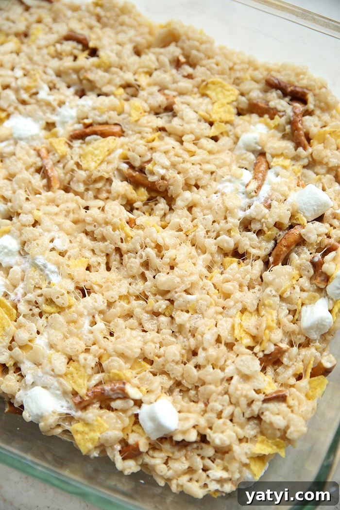 Partial picture of a glass 9x13 dish of sweet and salty Rice Krispies treats.