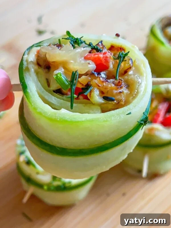 Fresh Vegan Cucumber Rolls: Light, Delicious Appetizer Recipe 7 A hand holds a skewer with a zucchini roll-up stuffed with vegetables.
