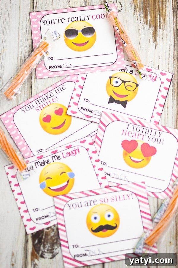 Printable Emoji Valentine Cards – Free Downloadable Pack 2 Cut out emoji valentines on a white wood background with orange sour straws