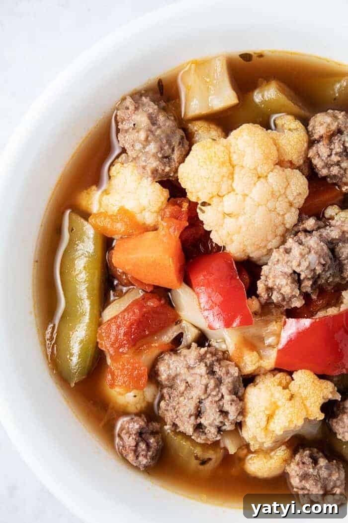 Hearty Keto Ground Beef Stew Recipe for Low-Carb Meals 15 keto beef vegetable soup in a large pot with spoon above