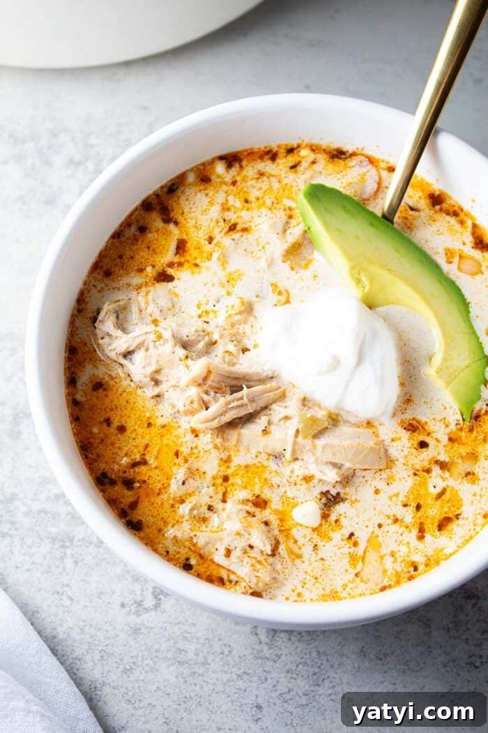 Hearty Keto Ground Beef Stew Recipe for Low-Carb Meals 16 bowl of keto white chicken chili garnished with avocado and sour cream