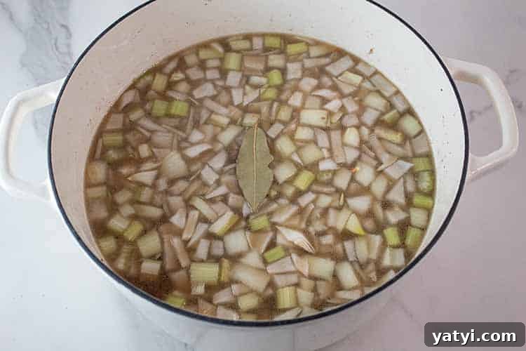 Hearty Keto Ground Beef Stew Recipe for Low-Carb Meals 3 overhead view of beef broth, water, celery and onions added to the Dutch oven