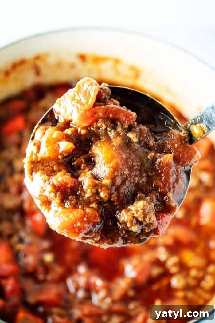 Hearty Keto Ground Beef Stew Recipe for Low-Carb Meals 10 ladle with big scoop of keto chili over pot