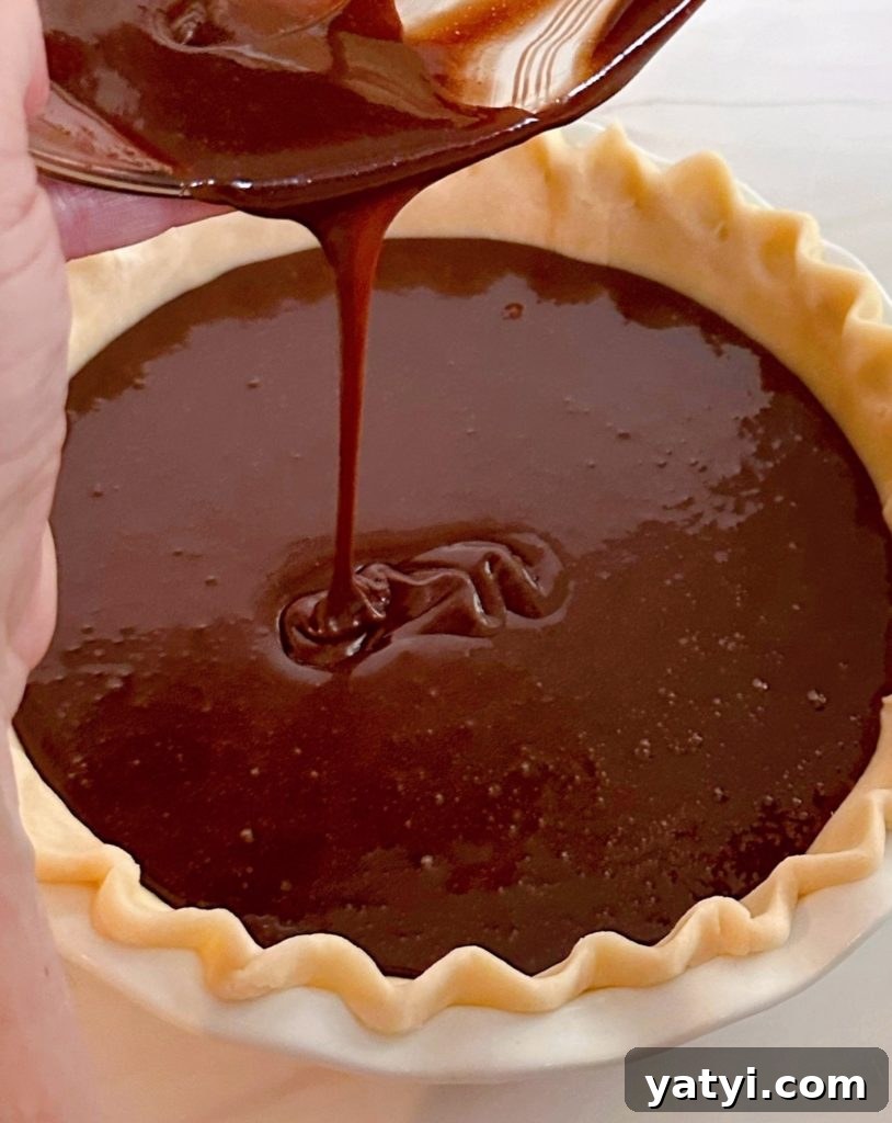 Decadent Chocolate Pecan Chess Pie Recipe for Home Bakers 9 Pouring chocolate pie filling into prepared pie crust.