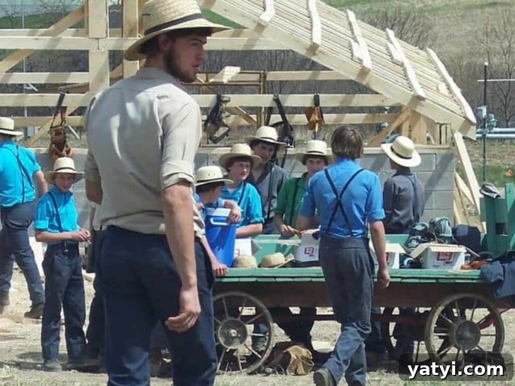 Origins of the Amish: Where They Came From and Why It Matters 5 Lots of Amish young men taking a break together at a barn raising.