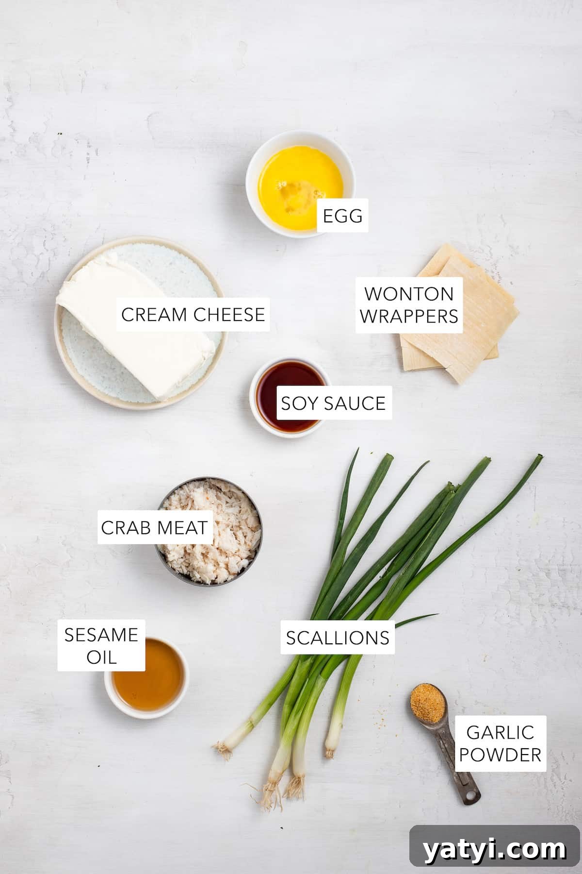 Ingredients for crab rangoon. Ingredients for crab rangoon labeled and separated into bowls.