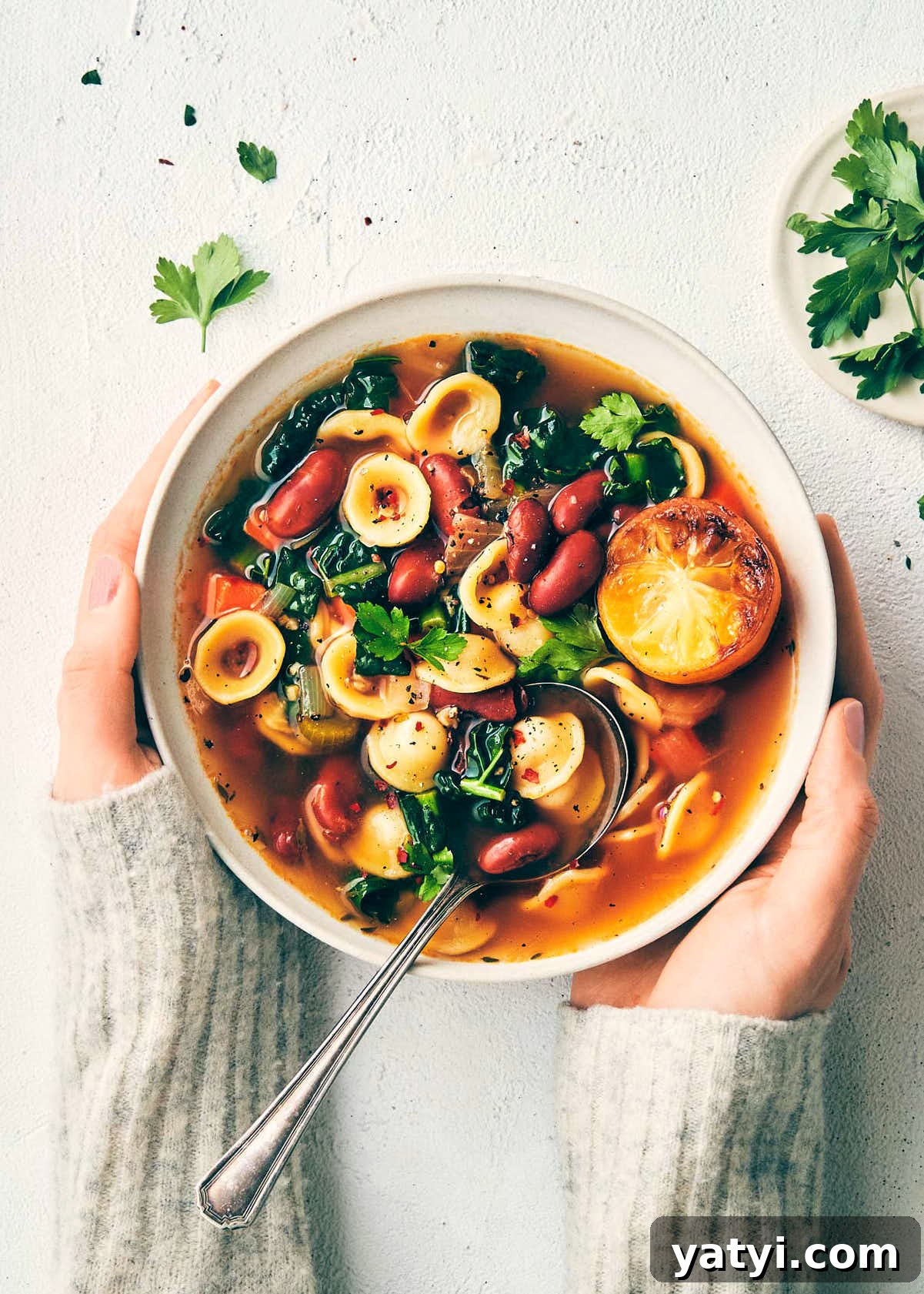 Veggie bean soup topped with roasted lemon topped with parsley