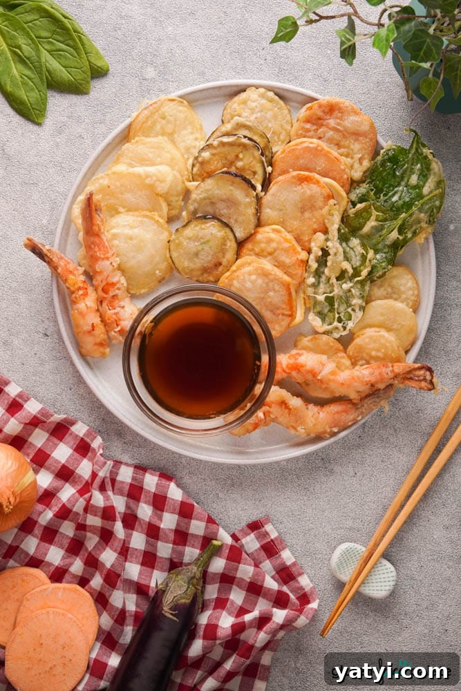 Crispy Gluten-Free Tempura Recipe: Light, Crunchy & Vegan-Friendly 7 Gluten-free tempura platter on a white serving plate with a dipping sauce.