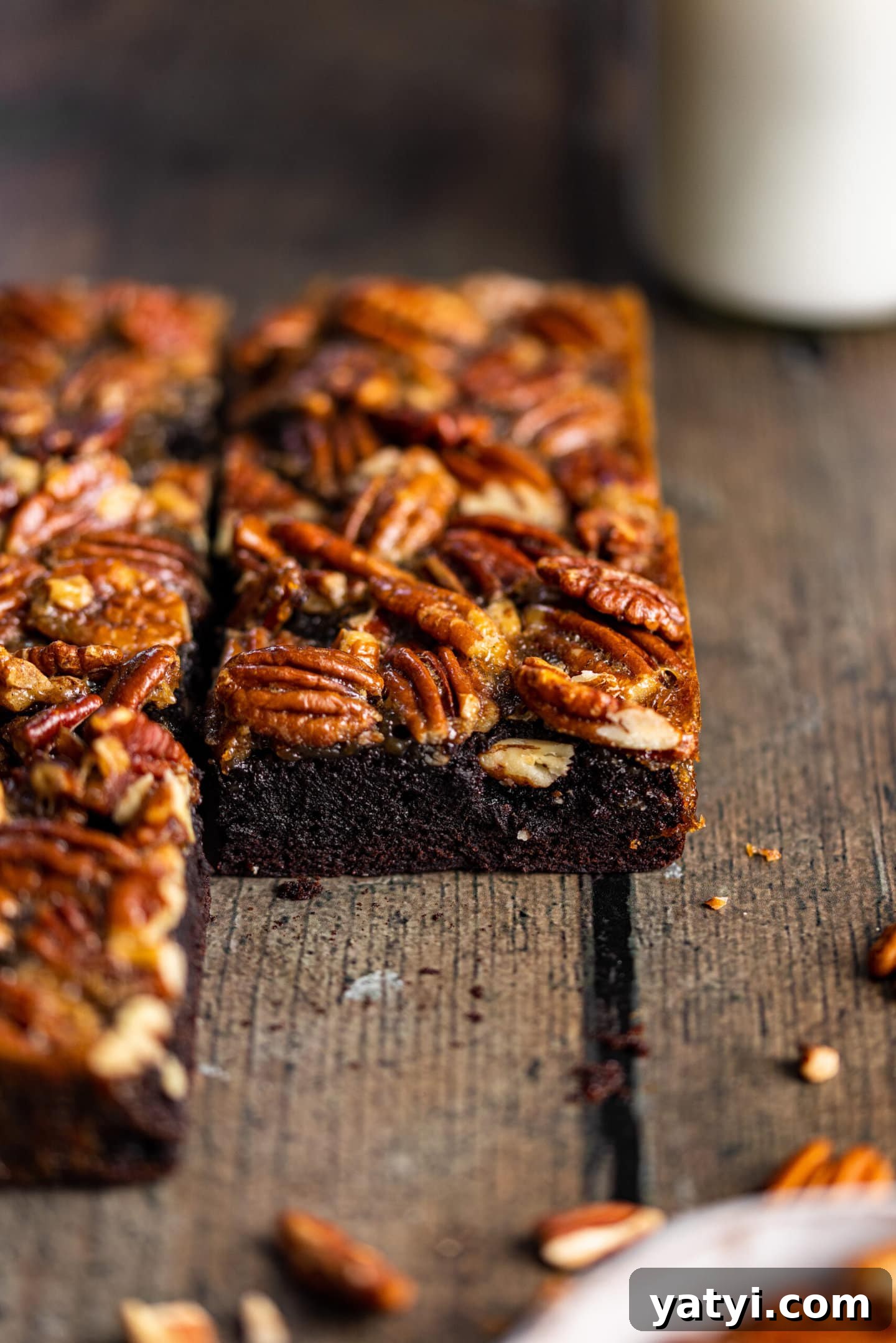 Decadent Pecan Pie Brownies Recipe — Gooey Chocolate Pecan Bars 3 Fudgy Pecan Pie Brownie slice next to glass of milk
