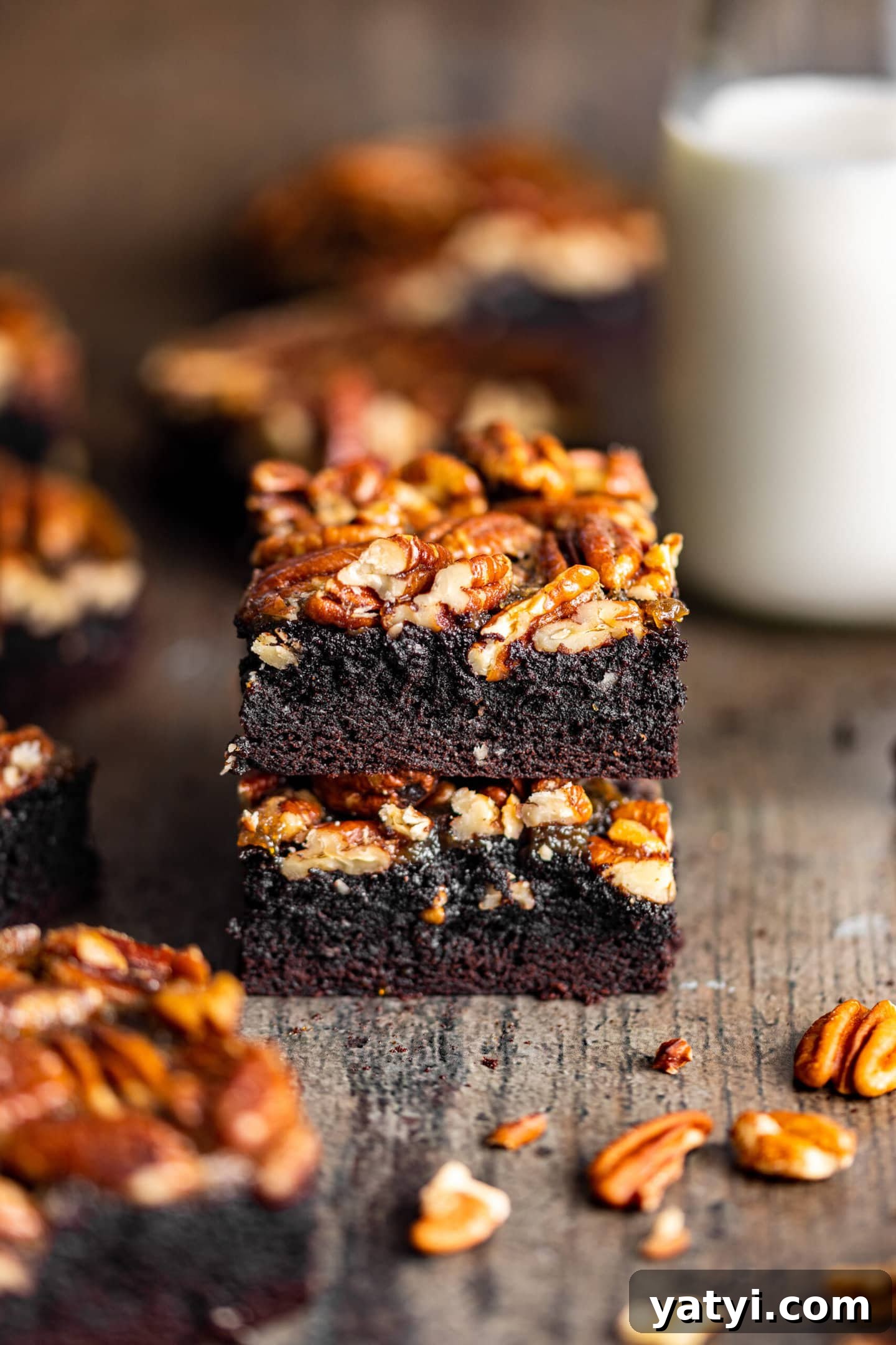 Decadent Pecan Pie Brownies Recipe — Gooey Chocolate Pecan Bars 5 Pecan Pie Brownies stacked on top of each other