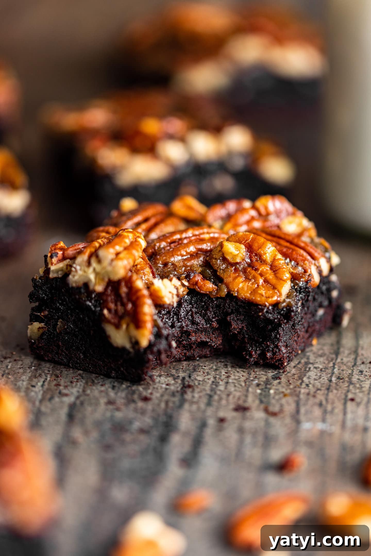 Decadent Pecan Pie Brownies Recipe — Gooey Chocolate Pecan Bars 8 Close up of brownie with a bite missing