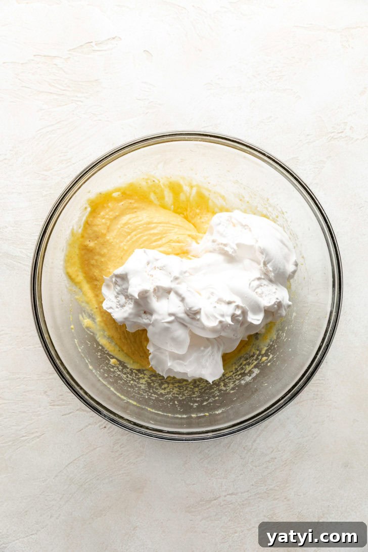 Mixing eggnog and whipped cream.