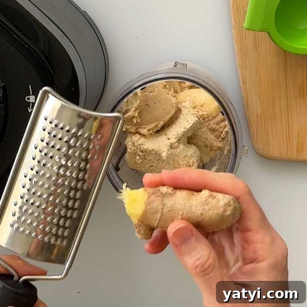 Pineapple, Cucumber & Ginger Detox Smoothie Recipe 6 Grating fresh ginger into the smoothie cup.