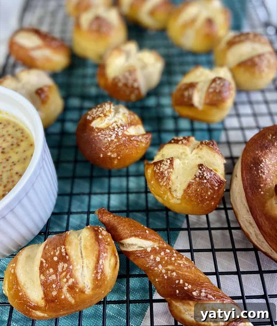 Soft Chewy Pretzel Bites with Buttery Salted Crust 2 Pretzel balls on black wire rack.
