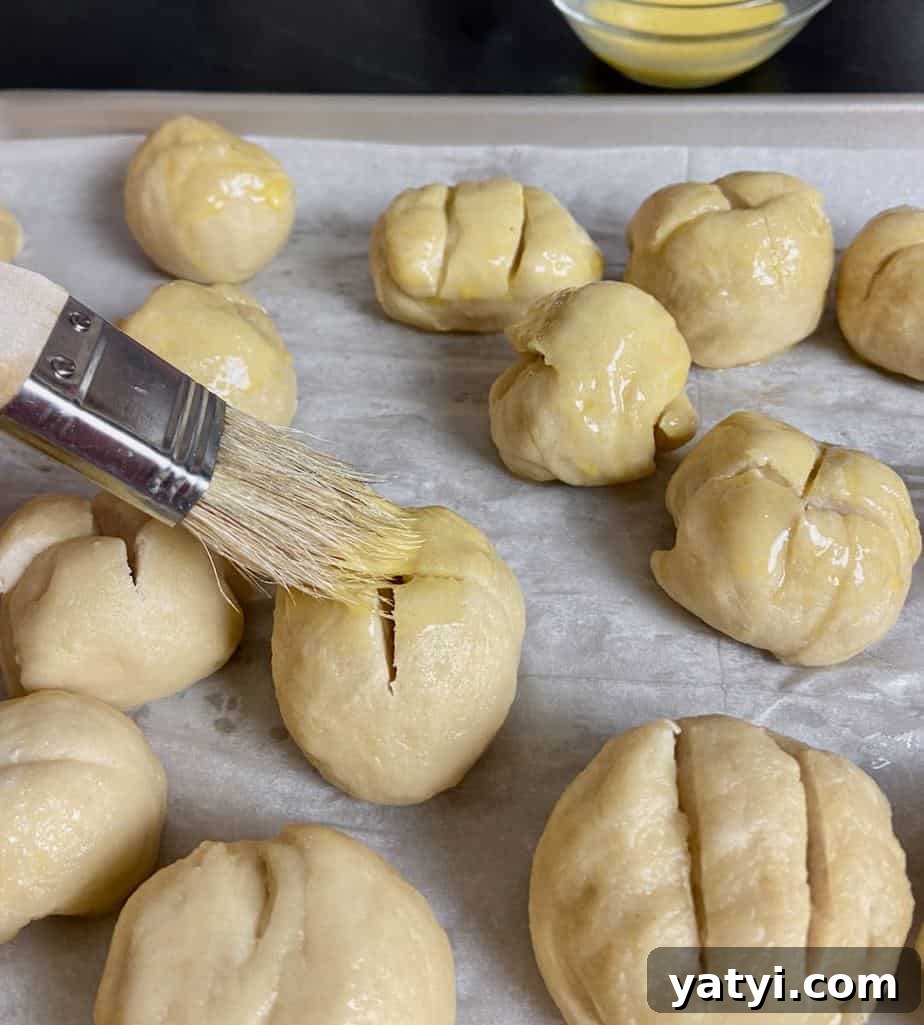 Soft Chewy Pretzel Bites with Buttery Salted Crust 5 Pretzel dough being brushed with egg wash with pastry brush.