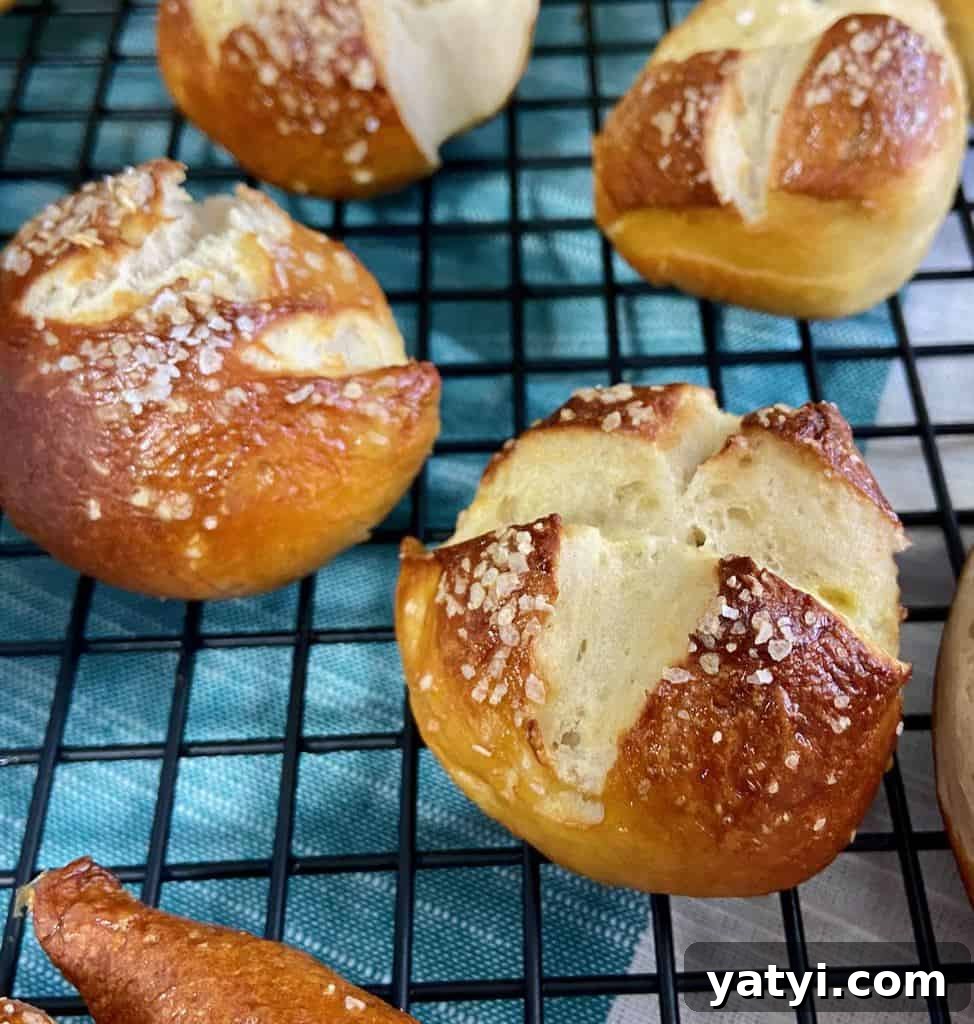 Soft Chewy Pretzel Bites with Buttery Salted Crust 6 Pretzel balls on black wire rack.