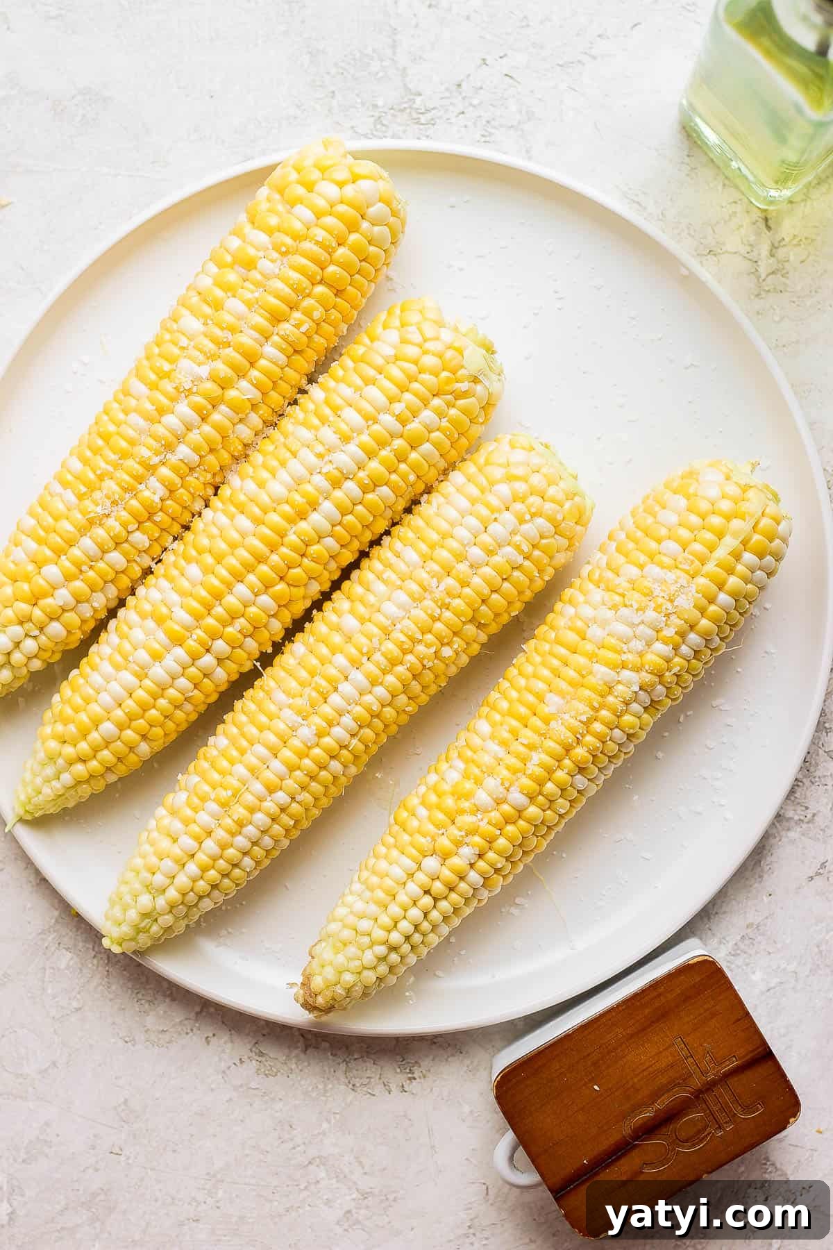 Ultimate Smoked Corn on the Cob Recipe for Sweet, Smoky Flavor 5 Four ears of sweet corn ready to go on the smoker.