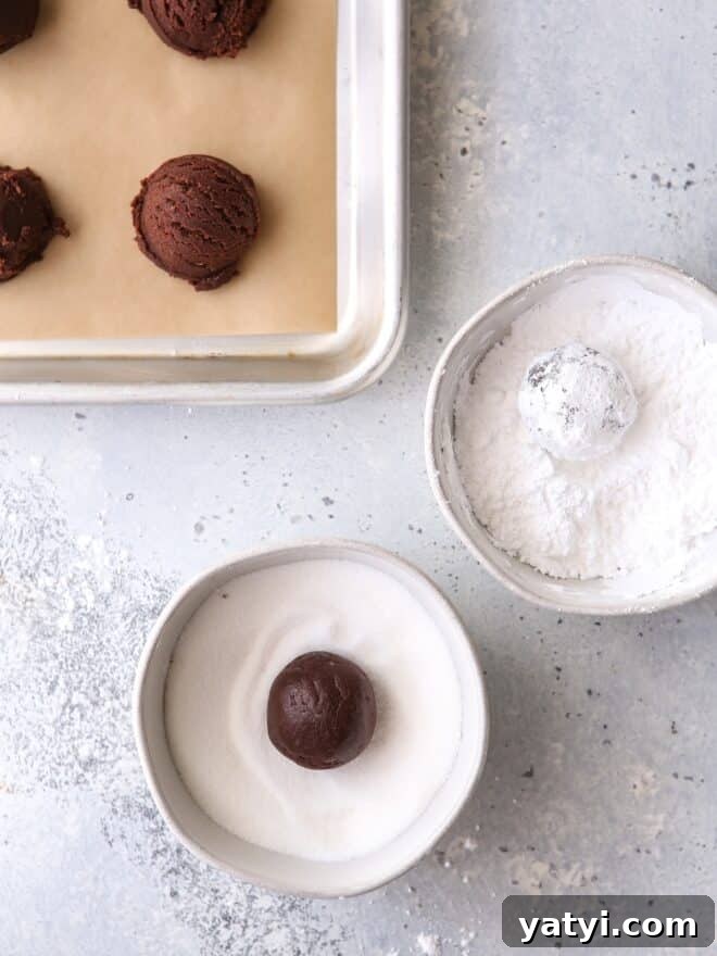 Roll cookies in granulated sugar and powdered sugar to prevent powdered sugar from absorbing into cookie
