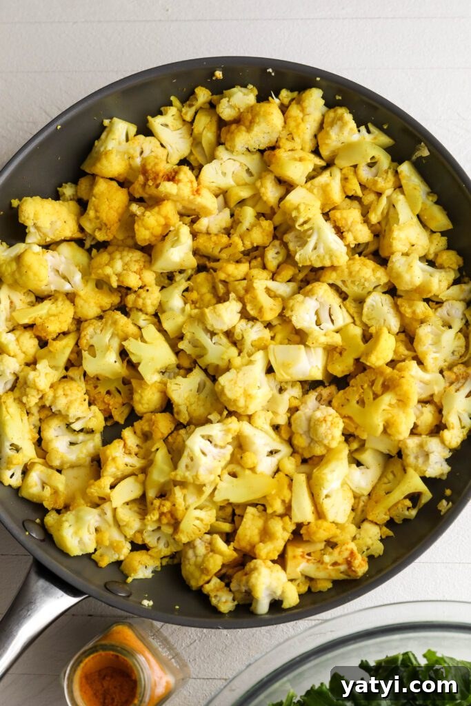 Curried Cauliflower and Kale Salad with Lemon-Tahini Dressing 5 Curried Cauliflower heated in pan by Flora & Vino