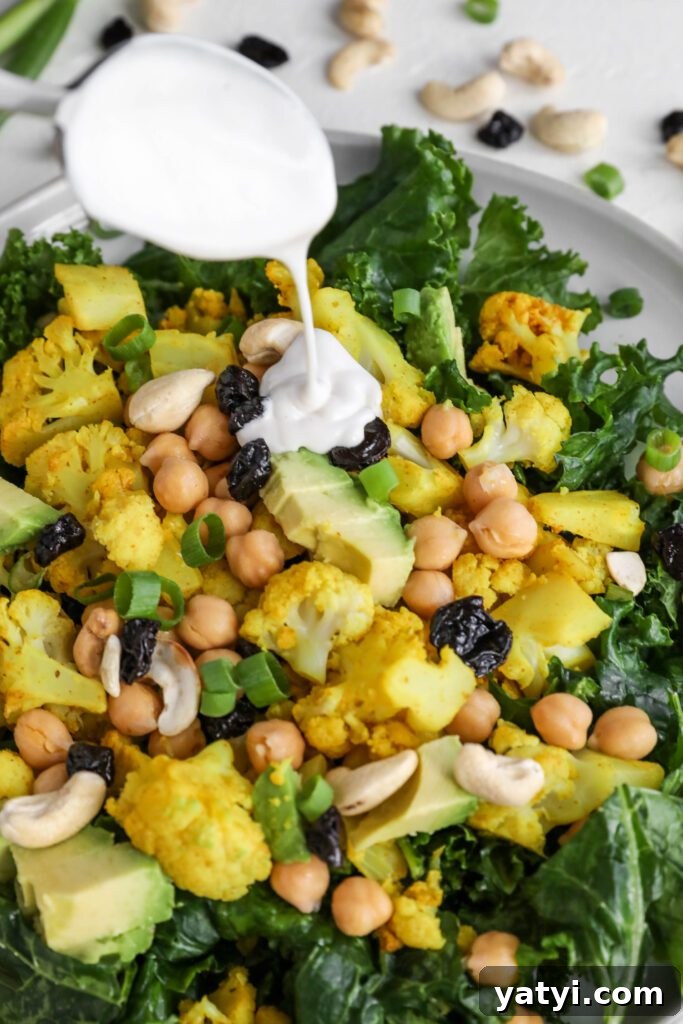 Curried Cauliflower and Kale Salad with Lemon-Tahini Dressing 7 Curried Cauliflower Kale Salad on plate drizzled with Yogurt Tahini by Flora & Vino