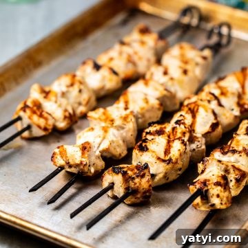 9 Grilled Chicken Breast Recipes to Fire Up Your Grill 2 Chicken skewers on a baking sheet.