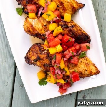 9 Grilled Chicken Breast Recipes to Fire Up Your Grill 3 Plate of grilled chicken topped with a mango watermelon salsa.