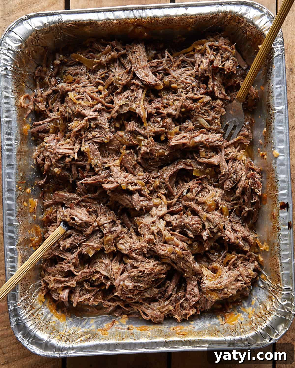 Fall-Apart Oven Chuck Roast Recipe for Tender, Juicy Beef 5 Overhead image of shredded chuck roast in oven recipe.